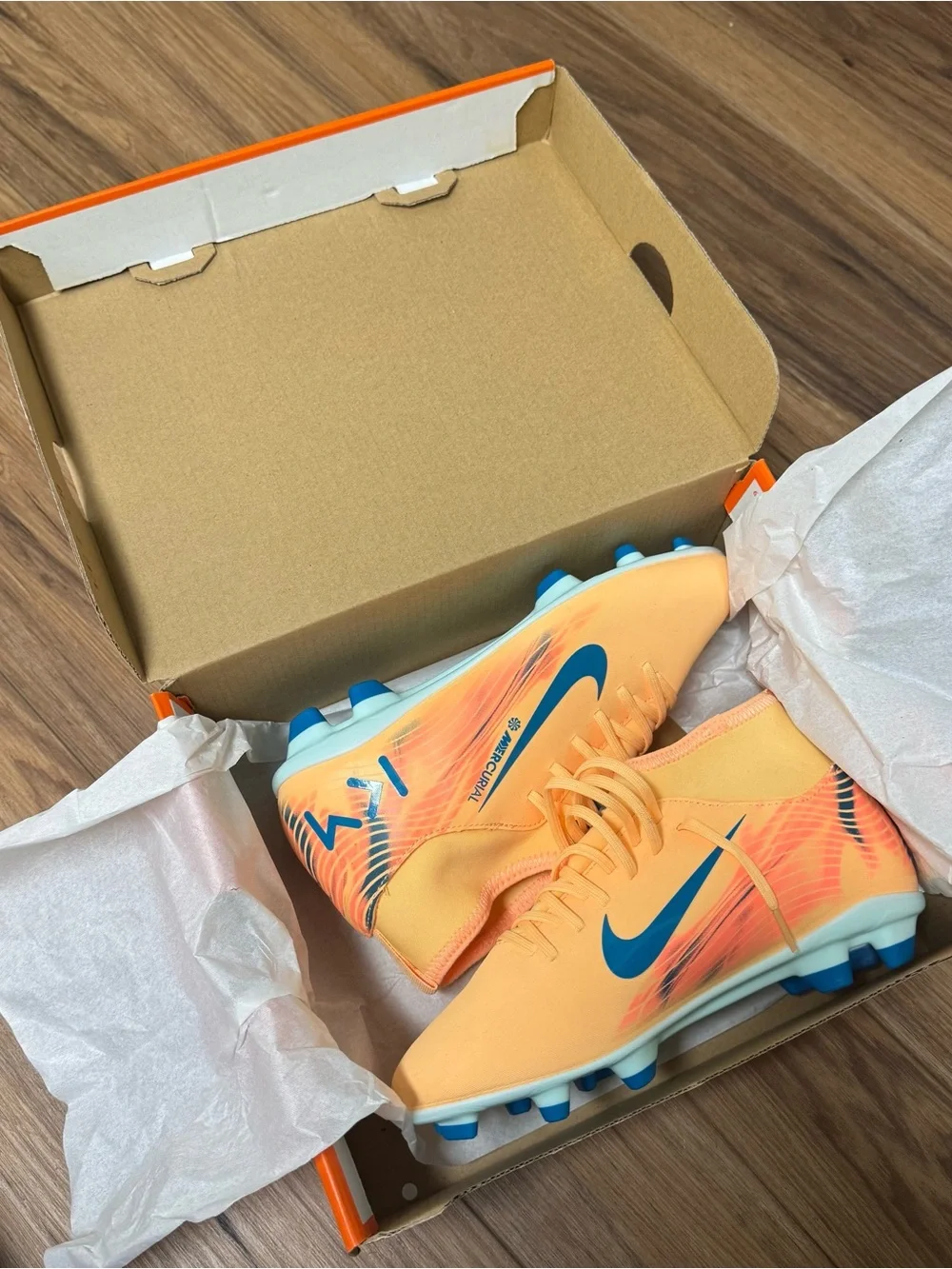 Nike Kids Orange Soccer Cleats with Blue Swoosh